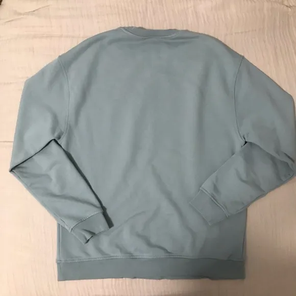 CLOSED branded light blue crew neck sweatshirts.