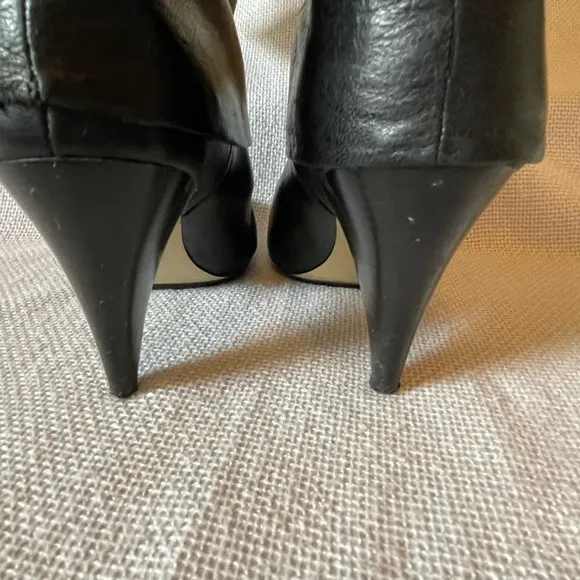 Michael.  Michael Kors black boots with buckle