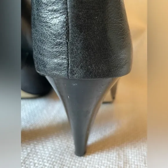 Michael.  Michael Kors black boots with buckle