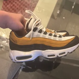 Nike Air Max 95 Sneakers in White, Gold, and Black