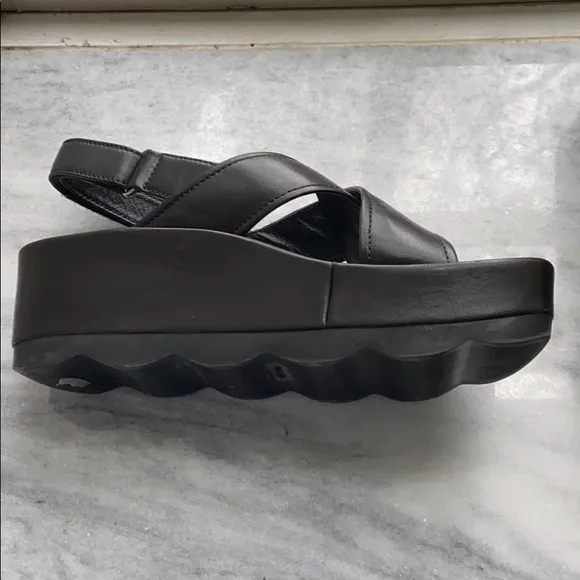 Prada cross cross sandals with wavy sole