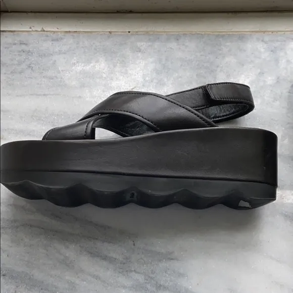 Prada cross cross sandals with wavy sole
