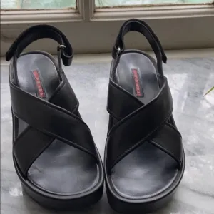 Prada cross cross sandals with wavy sole