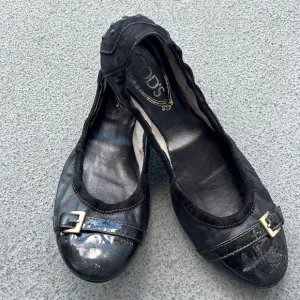Tod’s “Dee” Black Patent Leather Buckle Ballet Flats